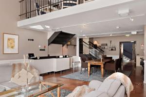 a living room with a staircase and a table at Best Western Plus Grand Hotel in Halmstad