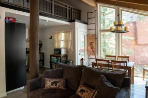 a living room with a brown couch and a kitchen at Golf Club Condos #437 in Truckee