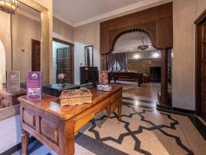a living room with a wooden desk and a room with a pool table at Villa Soraya Hammam & Jacuzzi in Marrakesh