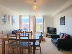 Una sala de estar con una mesa y un comedor. en Old Town Apartments, en Swindon