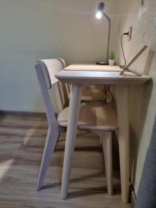 a desk with a chair and a table with a lamp at Isabel Guest House in Almada