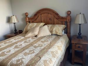 a bedroom with a bed with two night stands and two lamps at Villa in the Vines in Niagara on the Lake