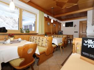 a restaurant with two tables and chairs and a window at Haus Daniela in Sölden