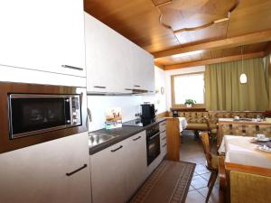 a kitchen with a sink and a microwave at Haus Daniela in Sölden