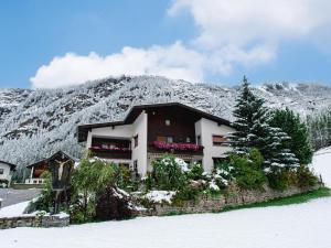a house in front of a snow covered mountain at Haus Daniela in Sölden