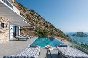 a villa with a swimming pool and a mountain at Villa Paganos in Volimes