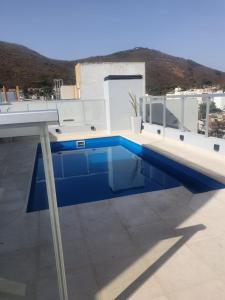 a swimming pool on the roof of a house at Hermoso departamento boutique con pileta in Salta