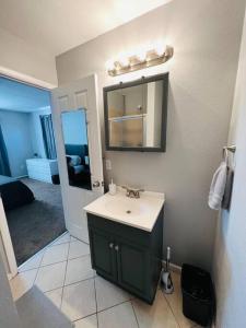 a bathroom with a sink and a mirror at Modern Home Near Downtown in Denver