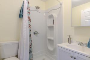 a white bathroom with a shower and a sink at Studio A mile from the best south Bay Beach in Redondo Beach