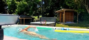 a person swimming in a swimming pool at Golden Caves - Bed & Breakfast in Takaka