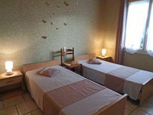 a hotel room with two beds and two lamps at Gîte Fontenoy-le-Château, 3 pièces, 4 personnes - FR-1-589-24 in Fontenoy-le-Château