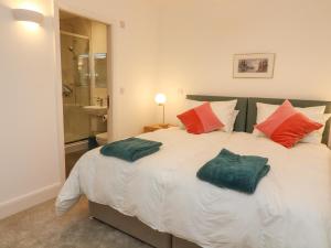 a bedroom with a large bed with pillows on it at Bronte House in Carnforth