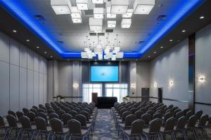 a conference room with chairs and a projection screen at Holiday Inn Express & Suites Sioux City North - Event Center by IHG in Dakota Dunes +67 photos