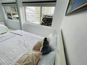 a stuffed animal sitting on a bed in a bedroom at Spectacular Views of Sydney Harbour with Free Parking in Sydney