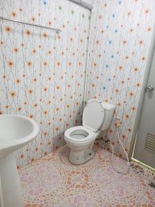 a bathroom with a toilet and a sink at Nu Phuket Airport Resident 1 in Nai Yang Beach