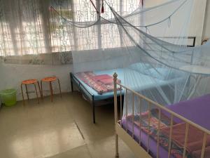 a bedroom with a bunk bed and two stools at Voyage Home&Guesthouse in Melaka