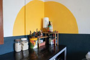 a counter in a kitchen with a yellow and blue wall at Osa de Rio in Uvita