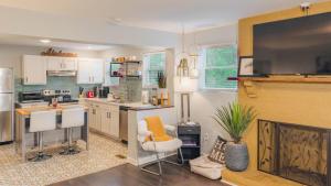 a kitchen with a fireplace and a kitchen with a tv at King bed open floorplan in heart of Bham in Birmingham +55 photos