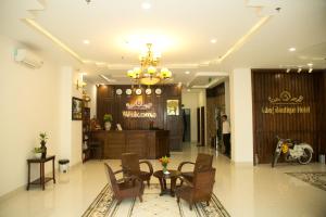 a lobby with a table and chairs in a building at BĂNG BOUTIQUE HOTEL in Thu Dau Mot