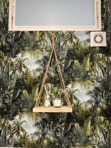 a shelf with three plants on a wall with palm trees at Prater Tree big 3 room apartment near Innere Stadt in Vienna