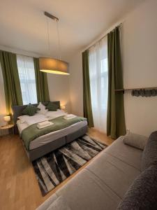 a bedroom with a bed and a couch at Prater Tree big 3 room apartment near Innere Stadt in Vienna