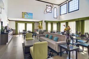 a lobby with a couch and chairs and tables at Comfort Inn & Suites Beachfront in Galveston