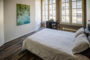 1 dormitorio con 1 cama grande en una habitación con ventanas en Le 402 en Montreal