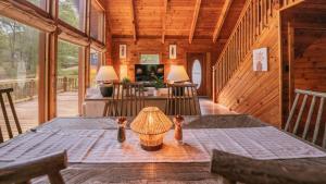 a dining room with a table in a cabin at Amenity Packed A-frame Cabin With Two Bedrooms And Loft in Gainesville