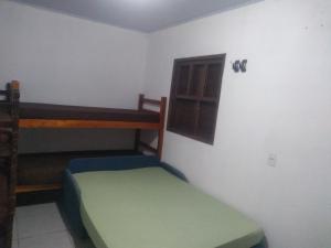 a small room with two bunk beds in it at Pousada Plataforma in Tramandaí