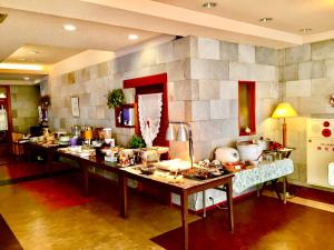a kitchen with a long counter with many items on it at Ougiya Ryokan in Hakuba