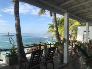 a porch with chairs and a view of the ocean at fantasea villa in Unawatuna