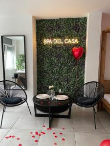 una habitación con 2 sillas y una mesa con un corazón rojo en Spa Palawan privé avec jacuzzi et sauna Liège, en Lieja