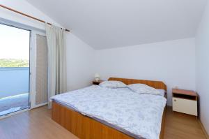 Postel nebo postele na pokoji v ubytování Apartments Anica J