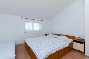 Postel nebo postele na pokoji v ubytování Apartments Anica J