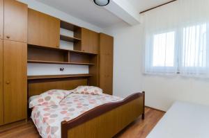 Postel nebo postele na pokoji v ubytování Apartments Anica J