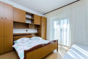 Postel nebo postele na pokoji v ubytování Apartments Anica J