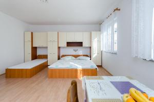 Postel nebo postele na pokoji v ubytování Apartments Anica J