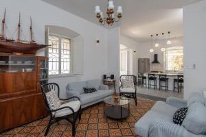 a living room with a blue couch and chairs at Villa Beachfront in Orebić