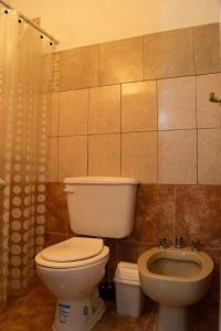 a bathroom with a toilet and a sink at Departamento NAMIVA II in Cordoba
