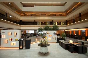 a lobby of a hotel with couches and tables at Hotel Metropolitan Premier Taipei in Taipei