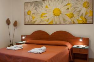 Residence Casa Del Mar Sicilia tesisinde bir odada yatak veya yataklar