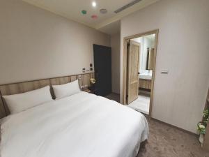 Rúm í herbergi á Grace Hotel Dunbei