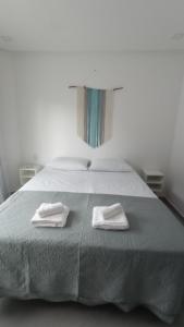 1 dormitorio con 1 cama con 2 toallas en Apartamento Maresia en Morro de São Paulo