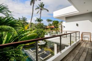 a balcony with a view of a house at Villa GoodFellas by BaliSuperHost in Seminyak