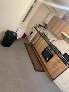 an aerial view of a kitchen with a stove top oven at Welcome to your new home. in Redbridge