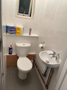 a bathroom with a toilet and a sink at Welcome to your new home. in Redbridge