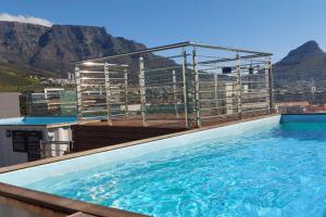 a large swimming pool on the roof of a building at Condo at Woodstock Quarters - Stylish 2 ensuite Bedroom Apartment with Spacious Balcony in Cape Town