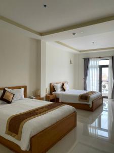 Giường trong phòng chung tại BĂNG BOUTIQUE HOTEL