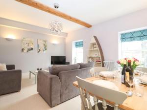 a living room with a couch and a table at Saffron, Blythview in Blythburgh