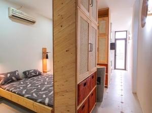 a bedroom with a bed and a wooden wall at the second home of yours in Hanoi